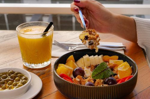 Enjoy a nutritious breakfast with fruit, nuts, and juice in a calm setting in İzmir, Türkiye.