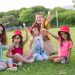 A joyful family enjoying ice cream on a sunny day in a Portuguese park.